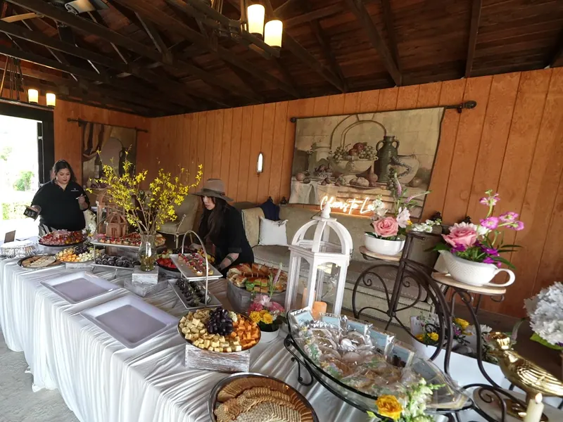 Long grazing and antipasto buffet with spring branches set in a wood-paneled Oakland event room