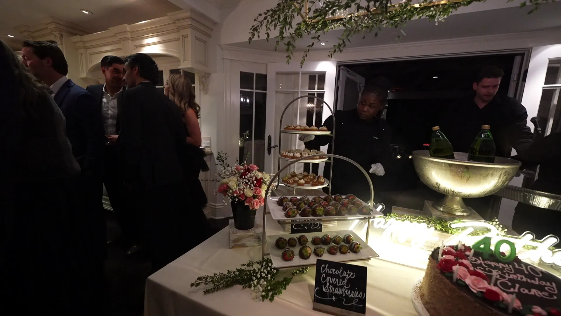 Guests gathered at a dessert tier and champagne station at a Hercules evening party