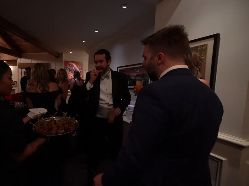 Server passing appetizers to guests during cocktail hour at a Pinole house party
