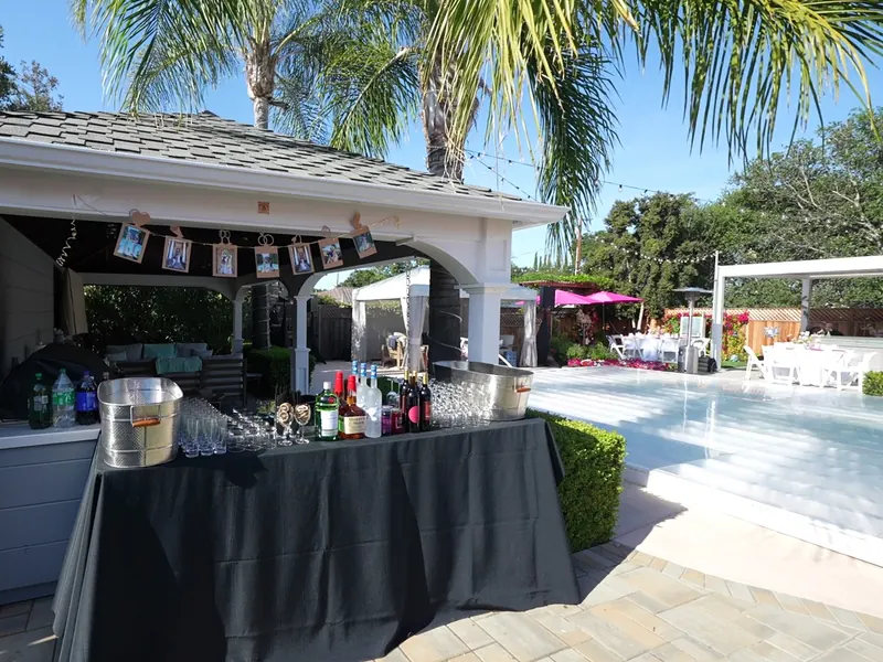 Bar and beverage station set beside the pool for a San Leandro backyard celebration