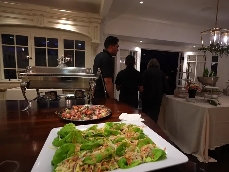 Hot buffet with chafing dishes and a shrimp platter set indoors for a Rodeo gathering