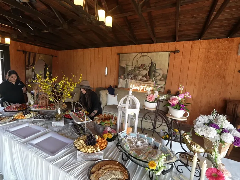Styled buffet with fresh florals and grazing platters at a Piedmont evening event