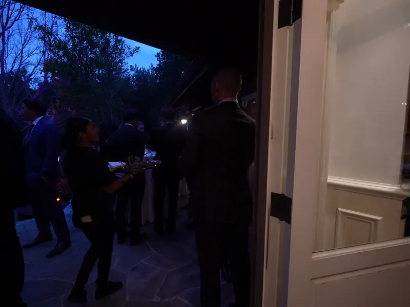 Server passing appetizers to guests at blue hour during a Rodeo evening event