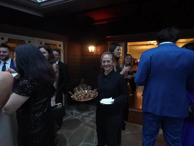 Server passing appetizers to guests on the patio at a San Pablo evening event