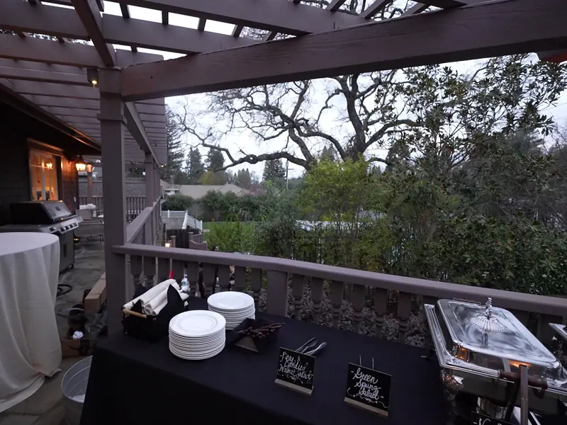 Dinner buffet with plated settings and chalkboard menus on an oak-shaded El Sobrante deck