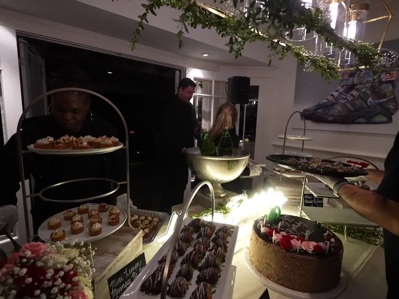 Dessert display with chocolate-dipped strawberries, cake and florals at a Pinole celebration