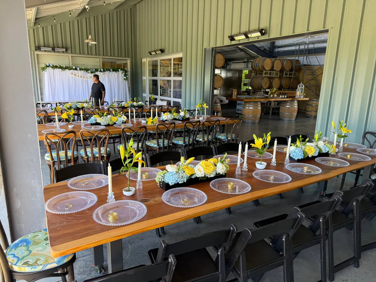 In-house floral centerpieces in low compotes with garden roses and greenery for an Oakland wedding by Oakland Catering Company